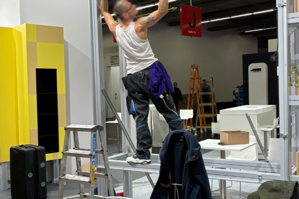 A man builds up the metal construction of the MVB-booth on Frankfurt Book Fair.